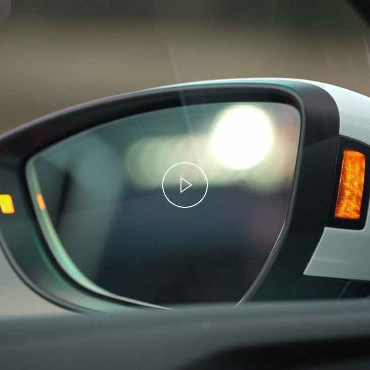  Close-up photo of the rear view mirror of an Audi vehicle. 