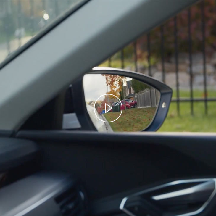 Photo of the side view mirror of an Audi vehicle.