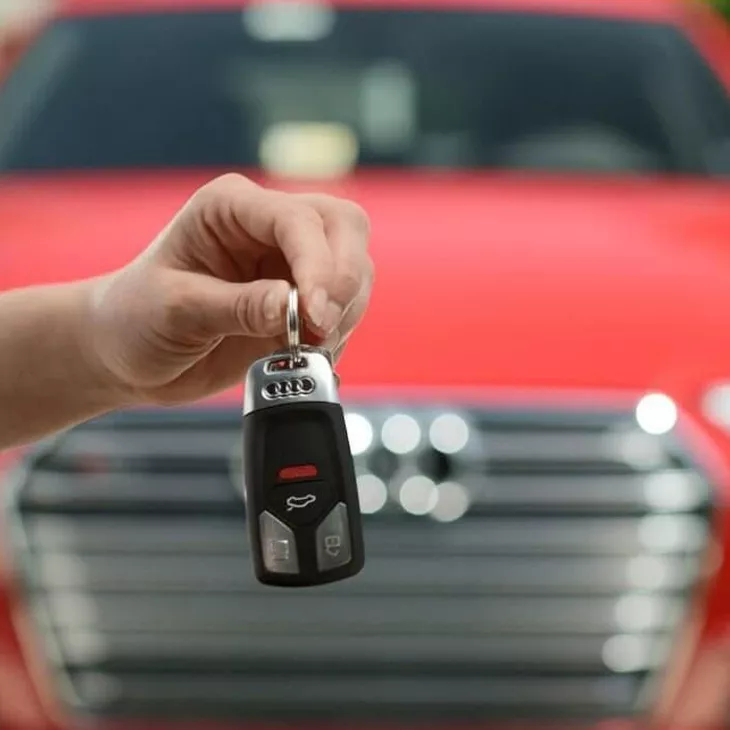 View of person holding Audi keys.