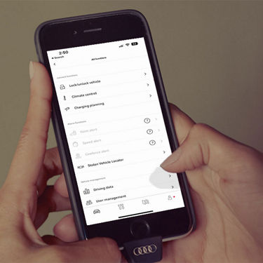 A person using the myAudi app on their smartphone to check their vehicle status.