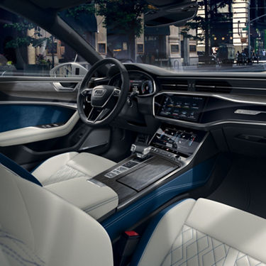 Interior shot of an Audi A7 with Ocean Blue door trim inserts, Black leather dashboard, fine grain ash wood inlays in natural noble gray, and Diamond Silver leather seating surfaces.