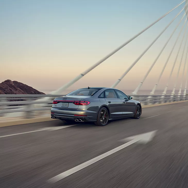 Three quarter rear view of the Audi S8 accelerating. 