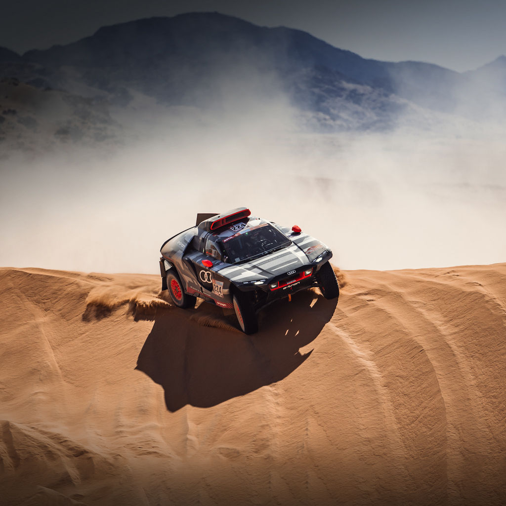 An Audi RS Q-etron tackles a sand dune in the 2022 Dakar Rally.