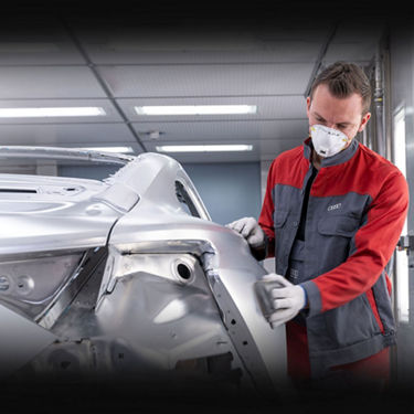  An Audi technician sanding the frame of an Audi Sport vehicle. 