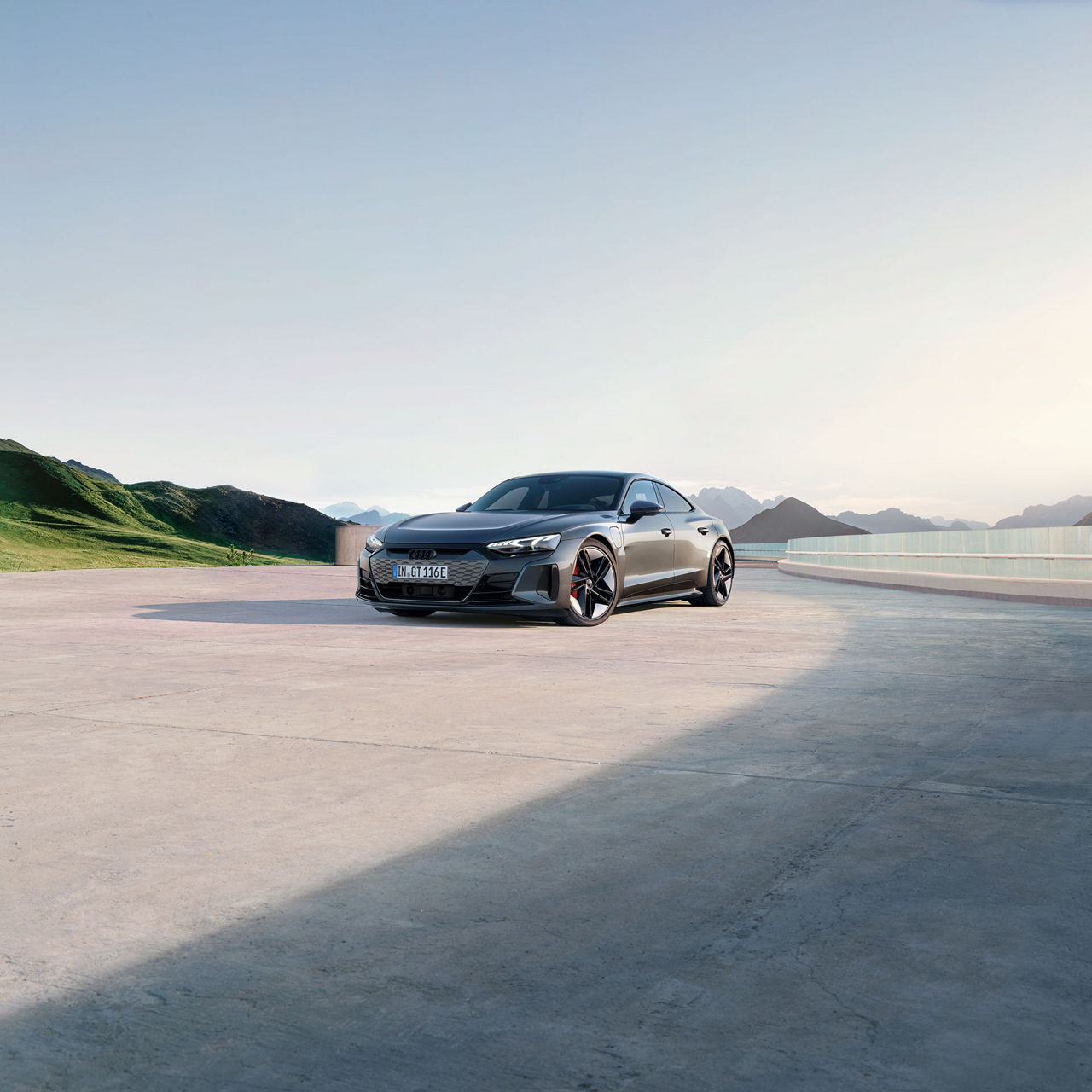 An RS e-tron GT driving on a coastal road. 