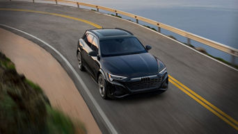 Bird's eye view of a black Audi Q8 e-tron in motion. 