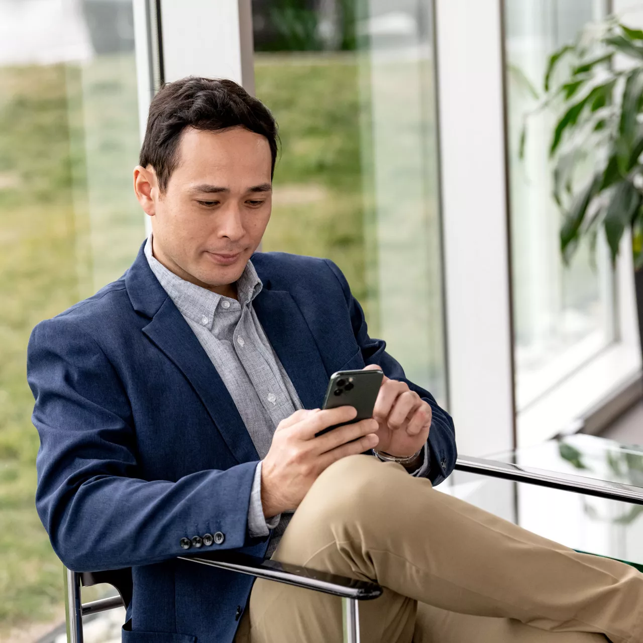 A well-dressed man receives the final invoice for his Audi on his phone. 