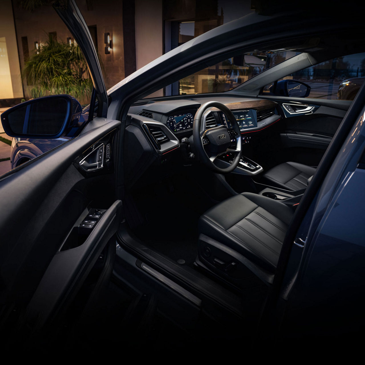 Interior shot of the illuminated cockpit and dashboard of an Audi.