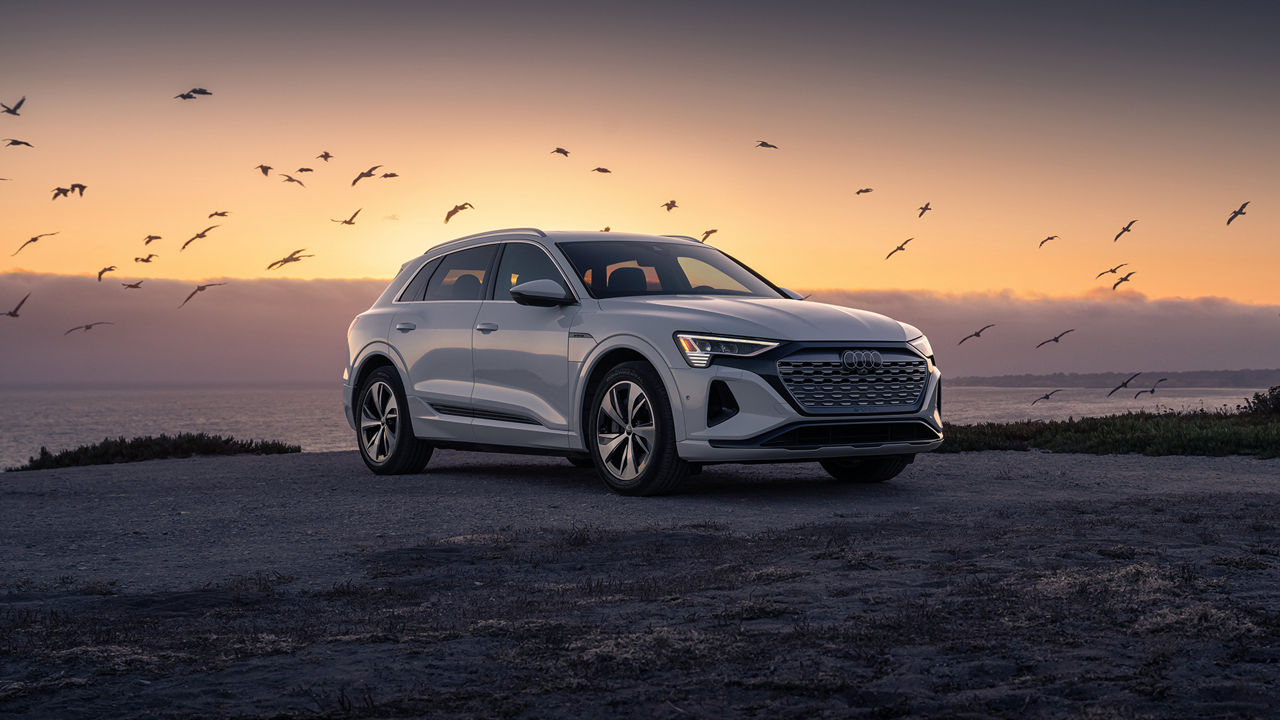 Three quarter front view of the Audi Q8 e-tron during sunset. 