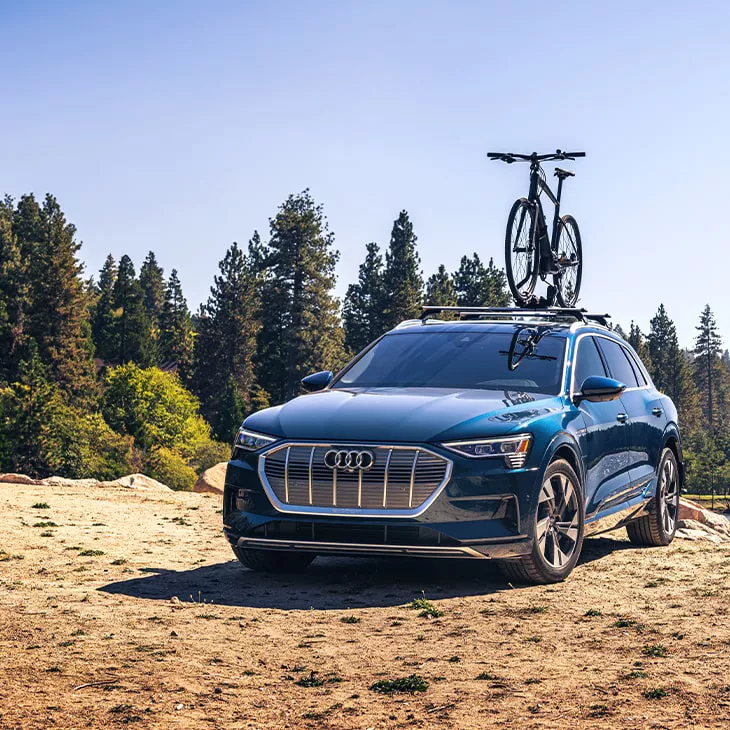 A bicycle mounted on top of an Audi e-tron®.