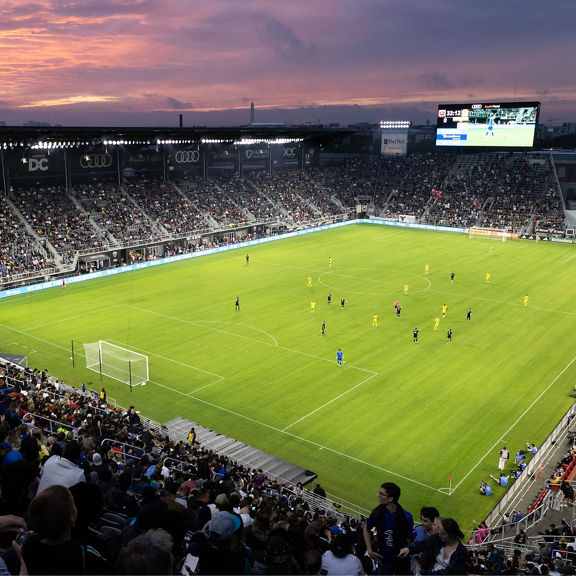 Wide-angle overhead shot of an evening soccer game at Audi Field.