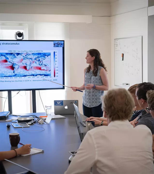 Image of a woman giving a presentation. 