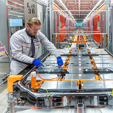 An Audi technician working on the battery of an e-tron vehicle. 