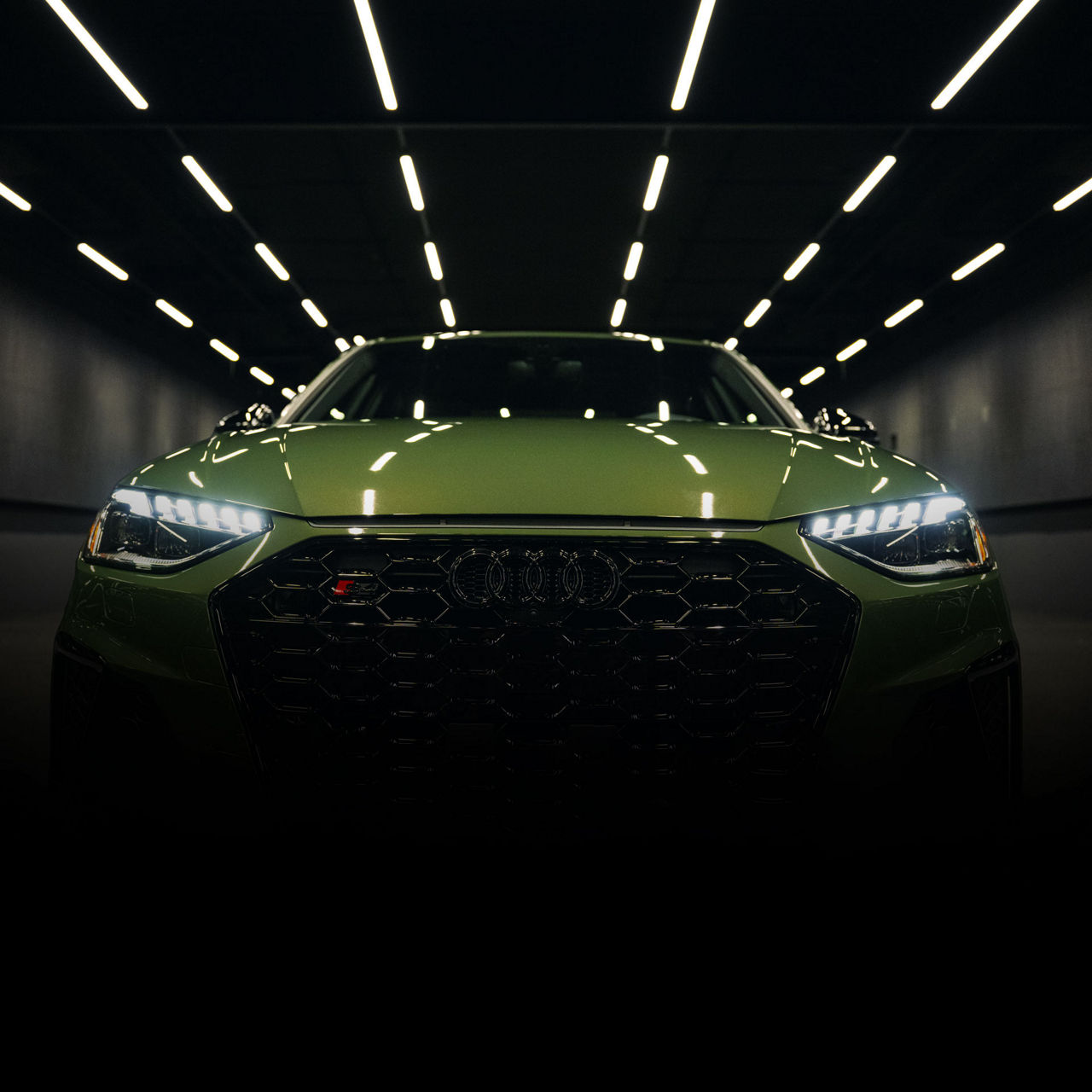 Close-up of the grille and headlights on a green Audi S4. 