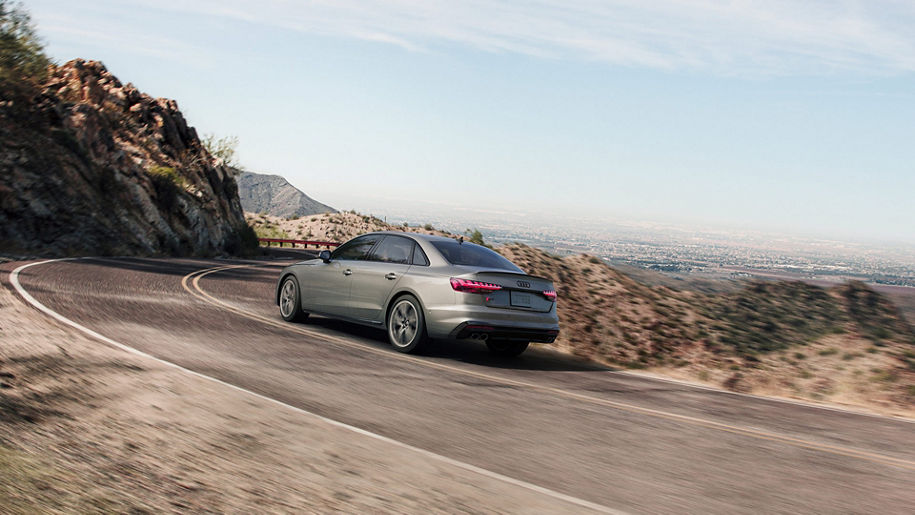 Three-quarter rear view of the Audi S4 accelerating.