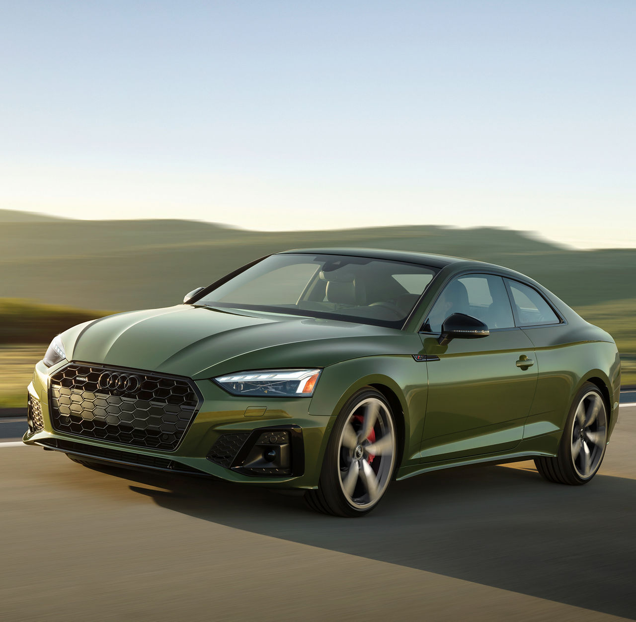 Three-quarter front view of the Audi A5 Coupe accelerating.