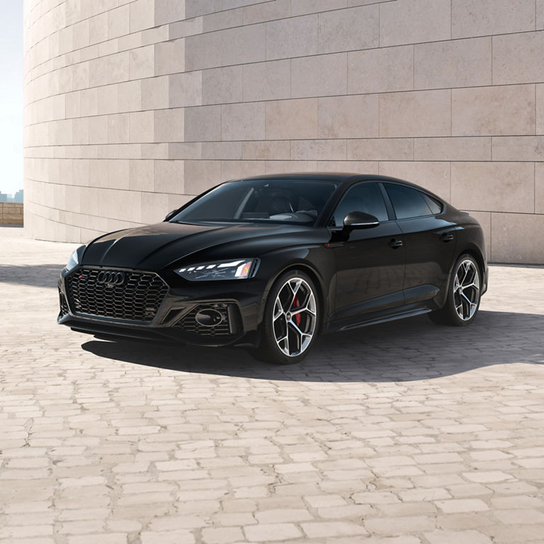 Three-quarter side profile of the Audi RS 5 Sportback parked.