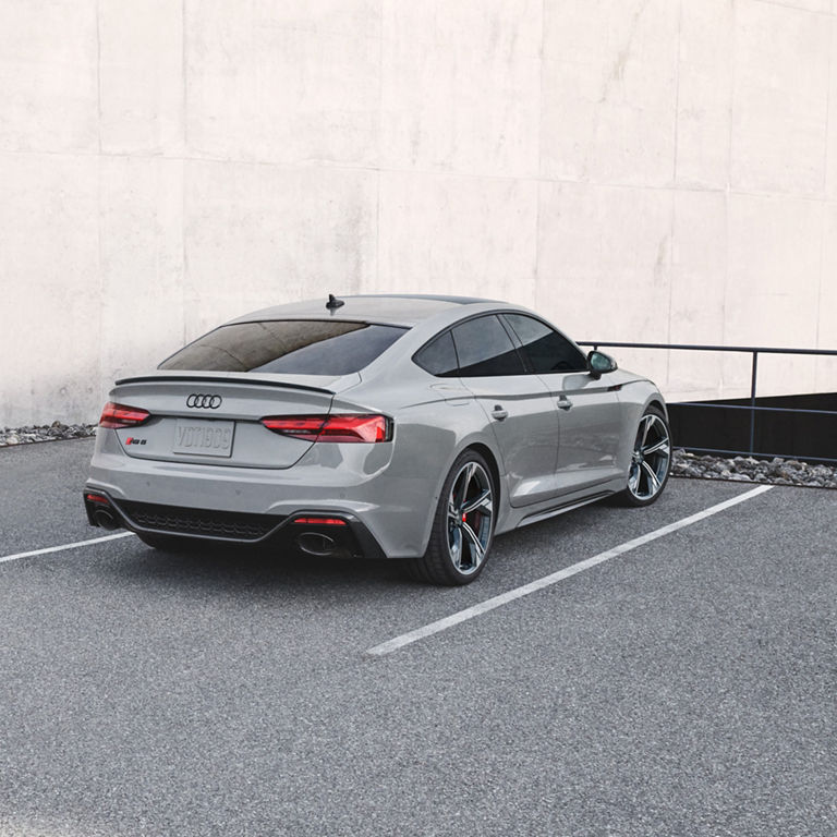 Three-quarter rear profile of the Audi RS5 Sportback parked.