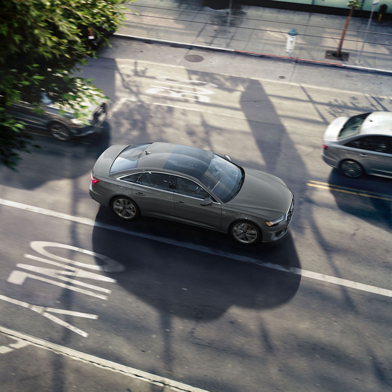 Aerial view of Audi A6 Sedan accelerating on an urban road.