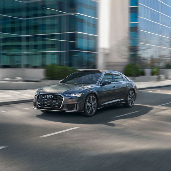 Front 3/4 view of an Audi A6 accelerating.