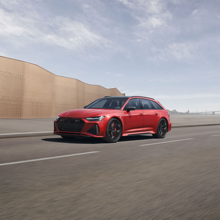 Three-quarter side view of the Audi RS 6 Avant accelerating.