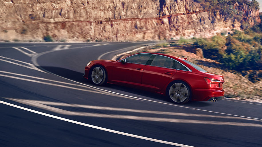 Three quarter side view of the Audi S6 Sedan accelerating.