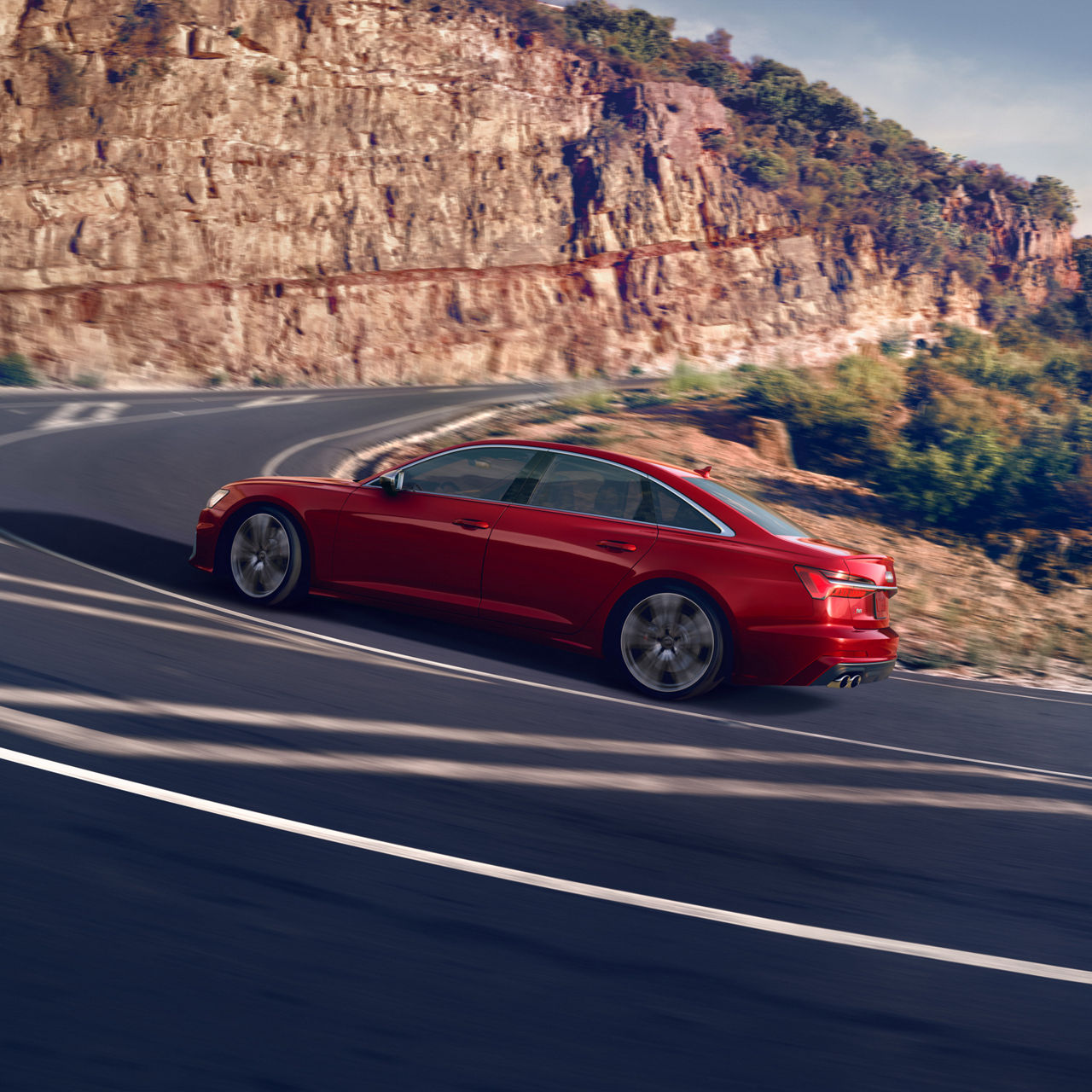 Three quarter side view of the Audi S6 Sedan accelerating.
