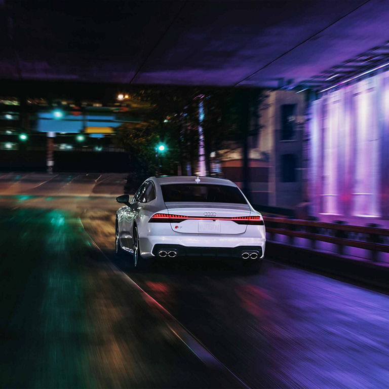 Rear profile of the Audi S7 in motion.