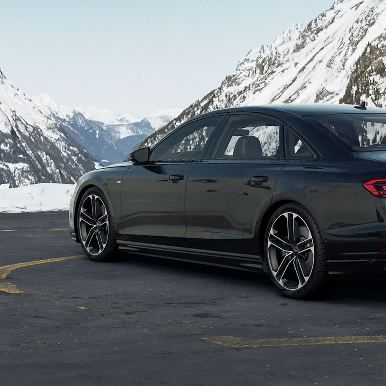 Rear 3/4 view of an Audi A8 parked.
