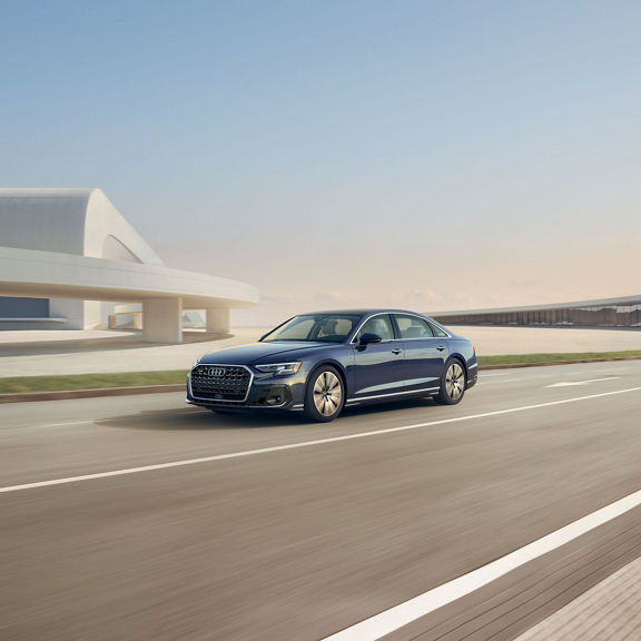 Three quarter front profile of the Audi A8 accelerating.