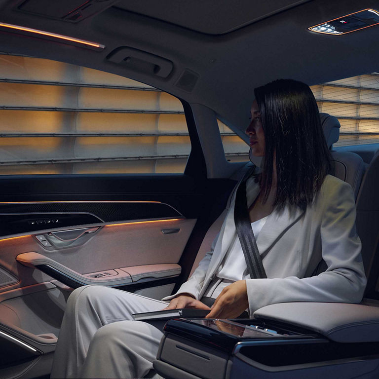 Interior view of a person sitting in the rear seat of the Audi S8. 