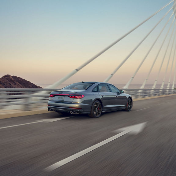 Three quarter rear view of the Audi S8 accelerating.