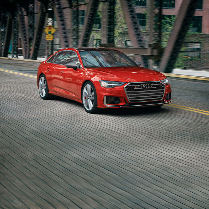 Three-quarter front view of the Audi S6 Sedan accelerating.