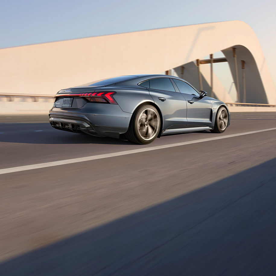 Side profile of the Audi e-tron GT accelerating.