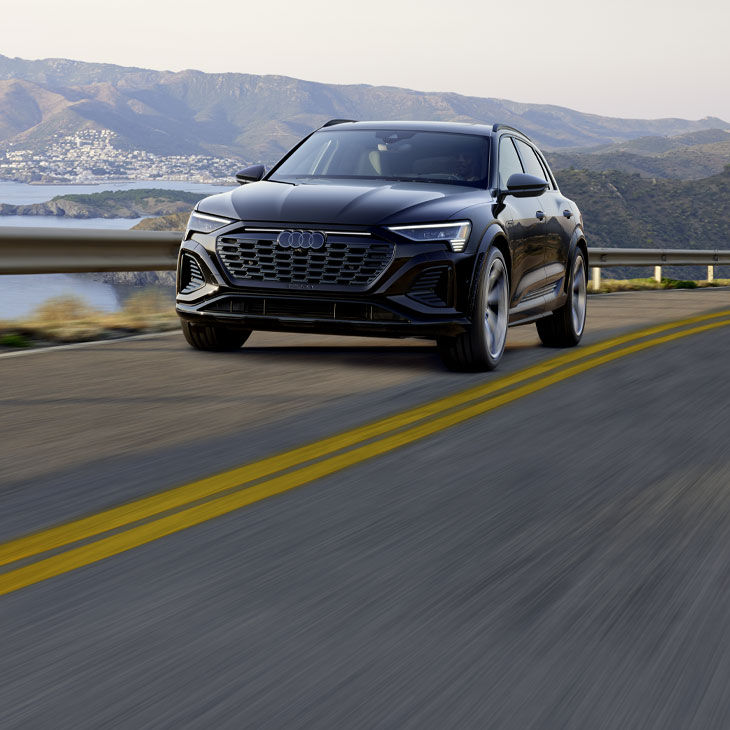 Three-quarter front view of the Audi SQ8 e-tron accelerating.