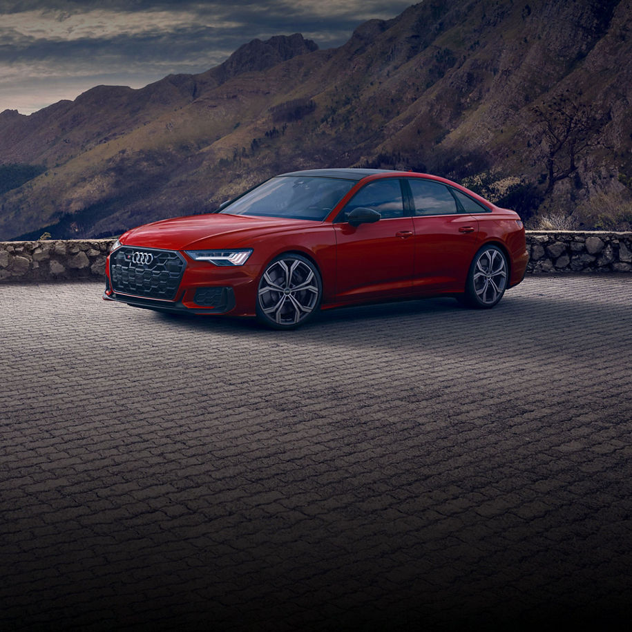 Three quarter side view of the Audi S6 Sedan parked.