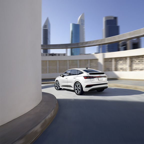 Rear profile of the Audi Q4 Sportback e-tron making a turn.