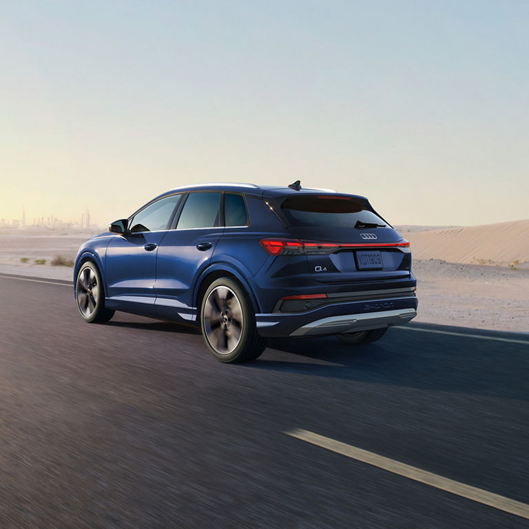  Three-quarter rear view of Audi Q4 e-tron® accelerating.