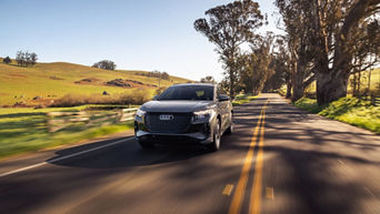 Three-quarter front view of the Audi Q4 e-tron making a turn. 