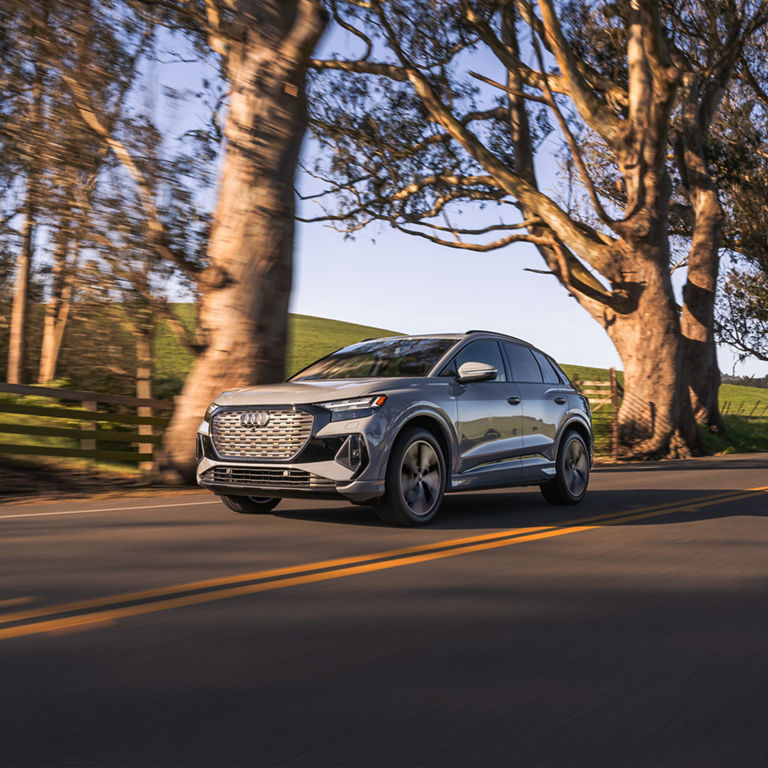 3/4 Side profile of the Audi Q4 e-tron in motion. 