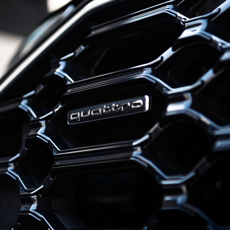 Close up on the quattro badge on the Audi Q5 PHEV. 