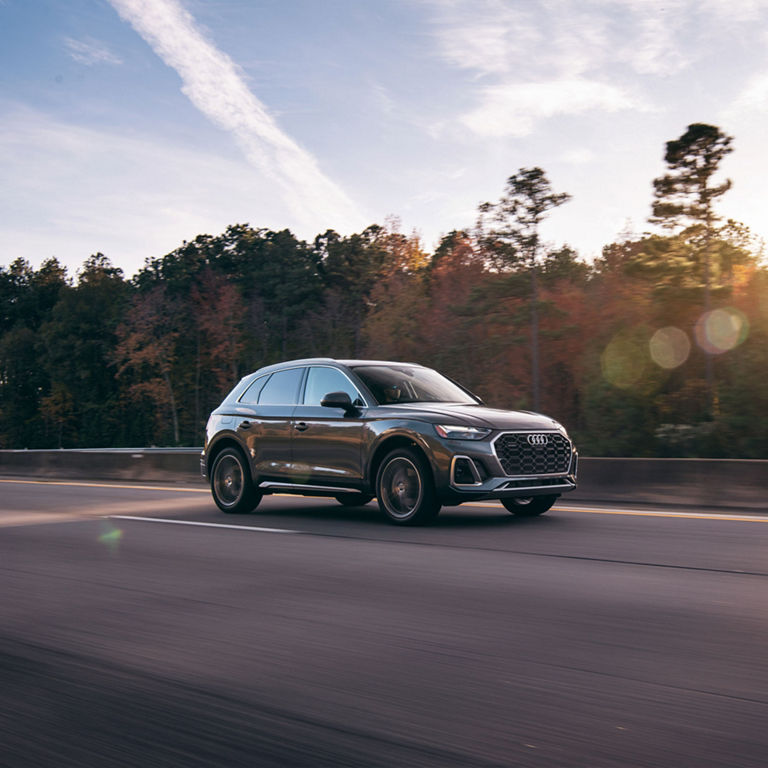 Side profile of the Audi Q5 PHEV in motion.