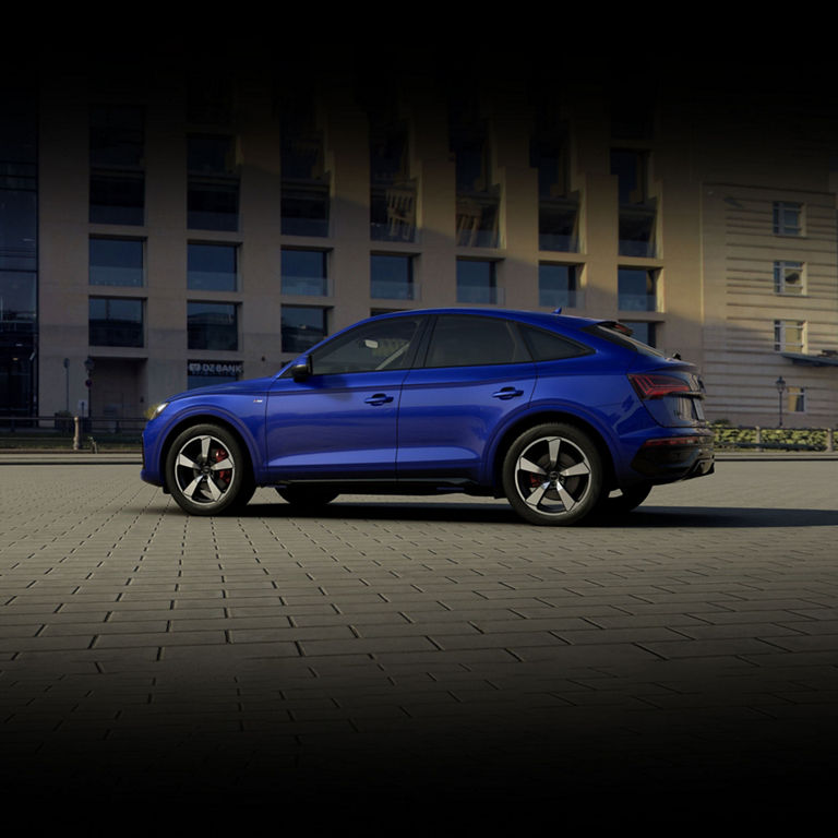 Side profile of a blue Audi Q5 Sportback parked.