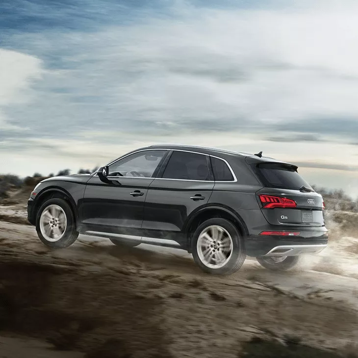 Side profile of the Audi Q5 driving off-road.