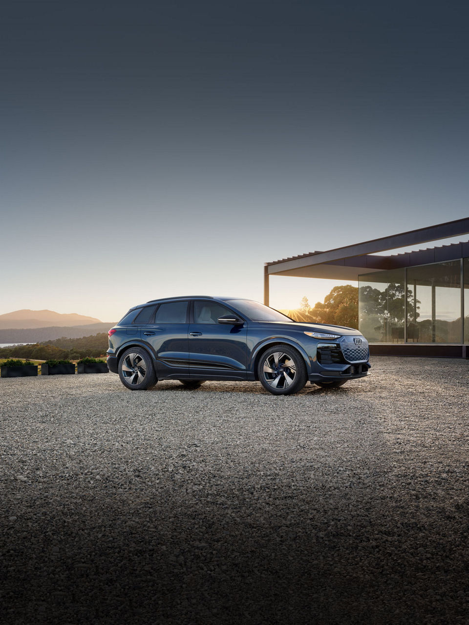 Three-quarter front view of the Audi Q6 e-tron parked.