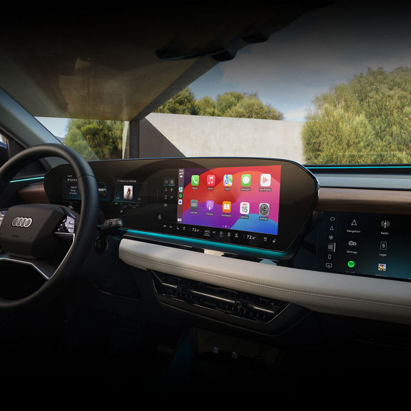 Interior view of the Audi Q6 e-tron dashboard including virtual cockpit, MMI touch display, and passenger side display.