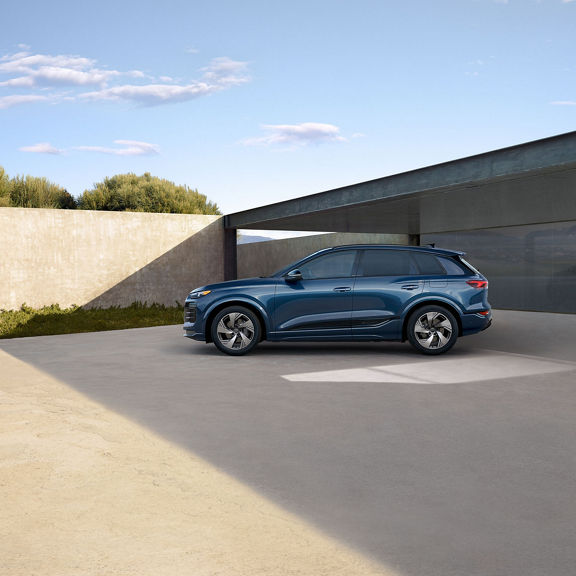 Side view of the Audi Q6 in motion.