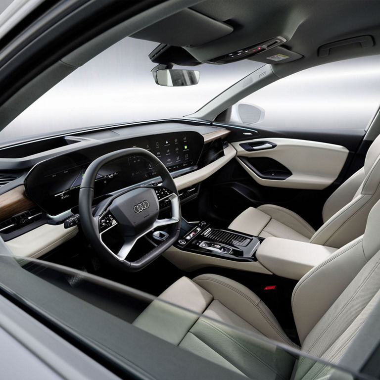 Interior view of the front seats and dashboard of the Audi Q6 e-tron.