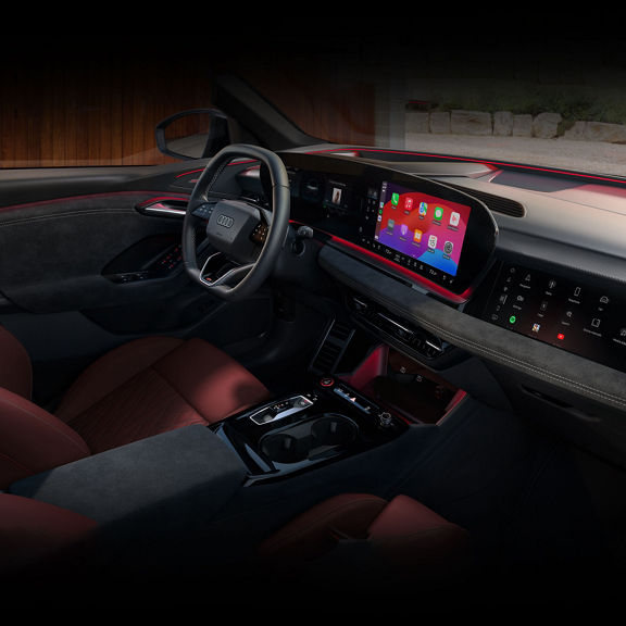 Interior view of the Audi Q6 e-tron dashboard including virtual cockpit, MMI touch display, and passenger side display.