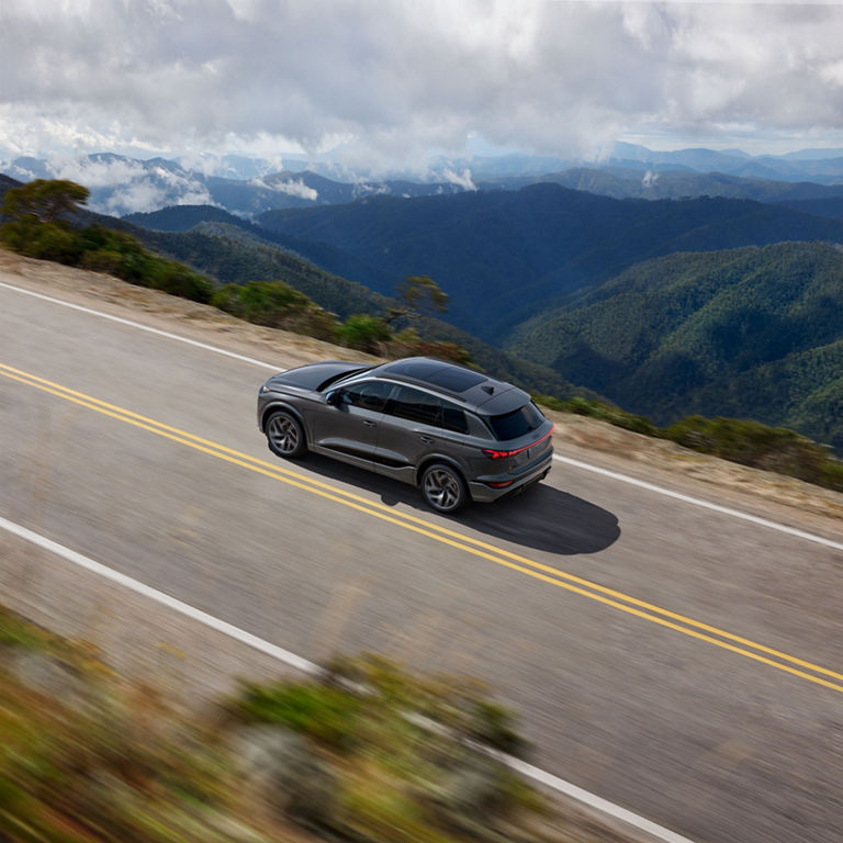 Aerial view of the Audi SQ6 e-tron accelerating on a mountain road.